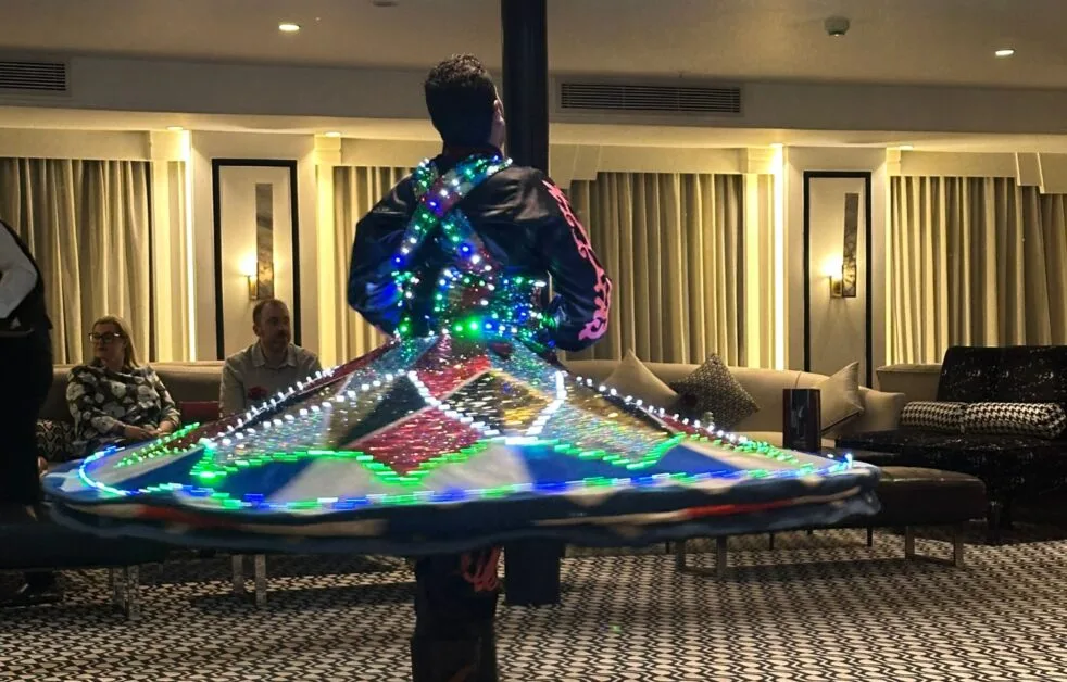 A whirling dervish dancer performing on Movenpick Hamees Cruise Boat.