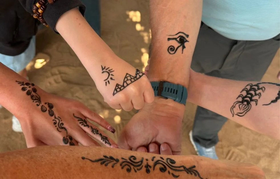 Family getting henna tattoos.