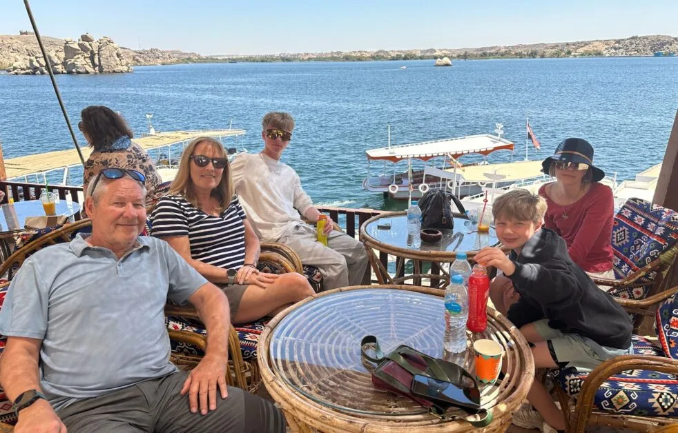 Family enjoying drinks at Philae Island Temple in Egypt.