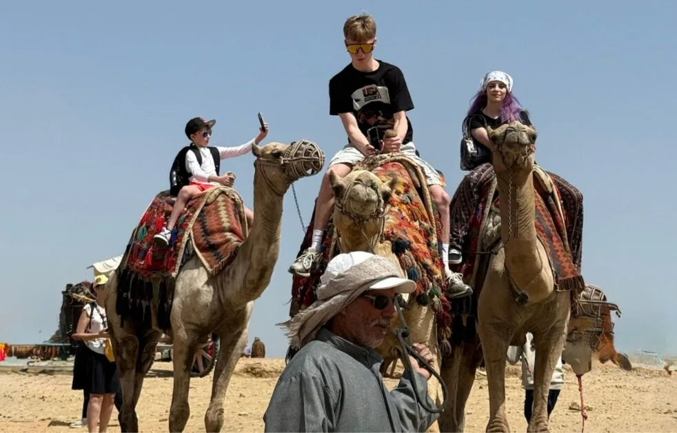 Teenagers Riding Camels in Giza, Egypt.