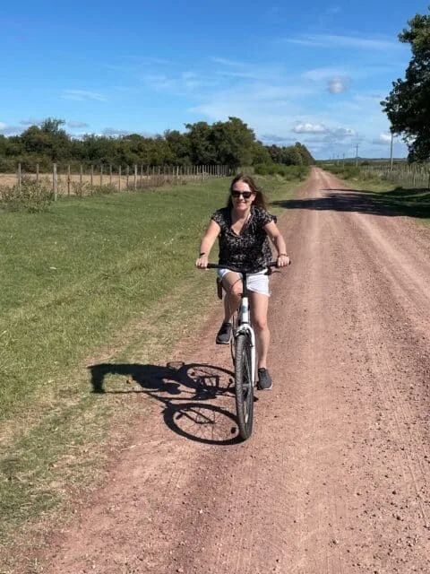 Woman on a bike in vineyards of Carmelo