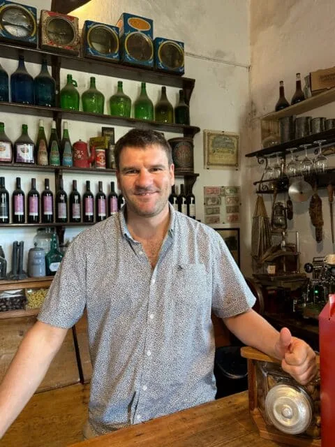 Owner of a winery in Carmelo welcomes guests in the shop.