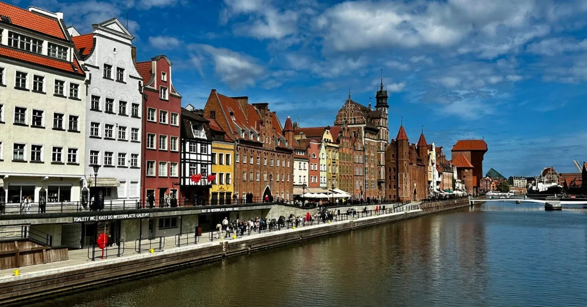 Gdańsk Riverside with traditional red roof buildings and pedestrian walkway.