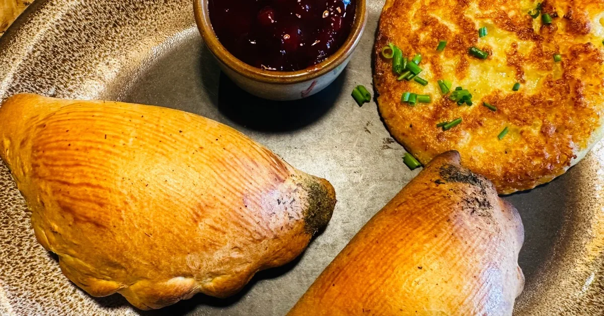 Baked pierogi and potato pancakes with cranberry sauce.