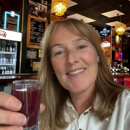 A woman drinking a vodka shot in Gdansk Poland.