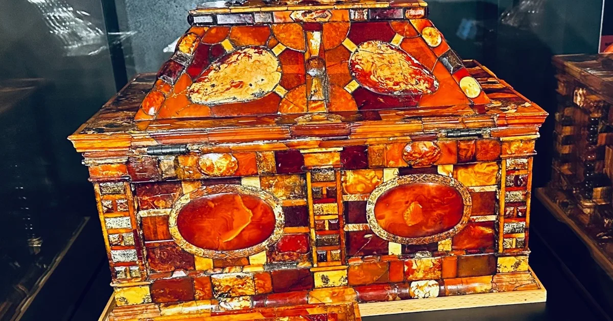 Baltic Amber inlay in a large box shows range of yellow and orange gems.