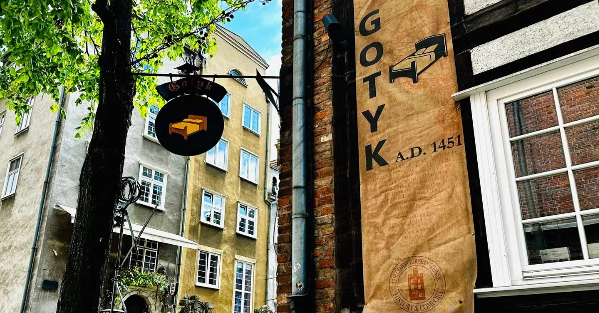 External sign for Gotyk Hotel, showing the building dates to AD 1451.