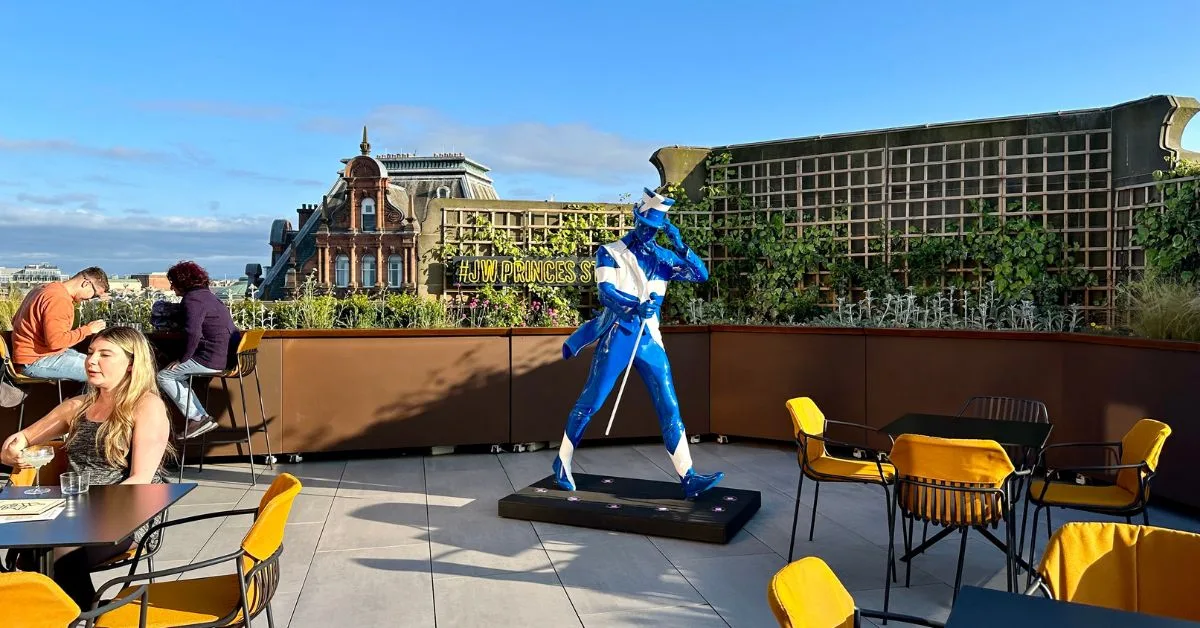 People sitting on a rooftop bar at Johnny Walkers Visitor Center in Edinburgh.