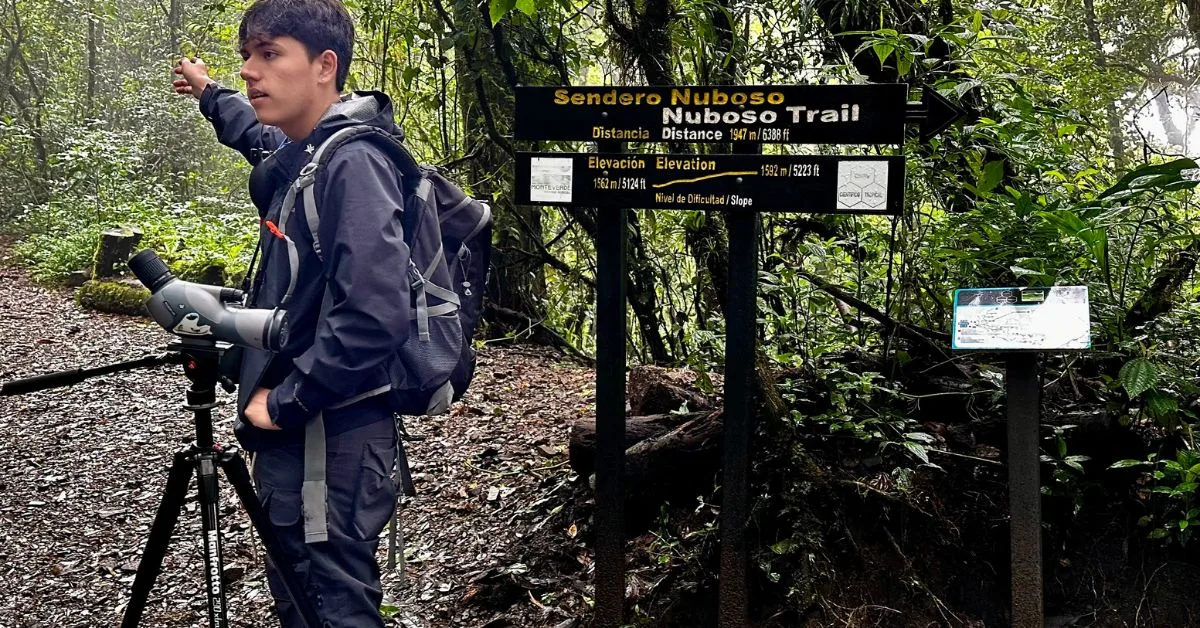 Guide in the cloud forest in Monteverde with a sign showing the forest trails you can take.