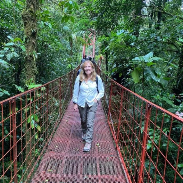 Crossing a hanging bridge in Monteverde Cloud Forest.