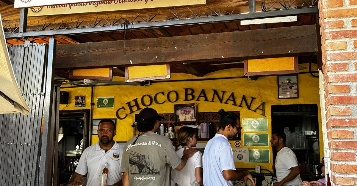 Entrance to Choco Banana Restaurant with customers and staff.