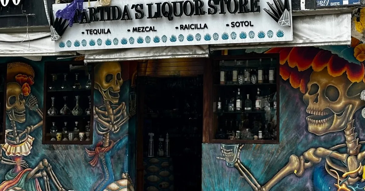 Tequila store with painted skeletons on the outside wall.