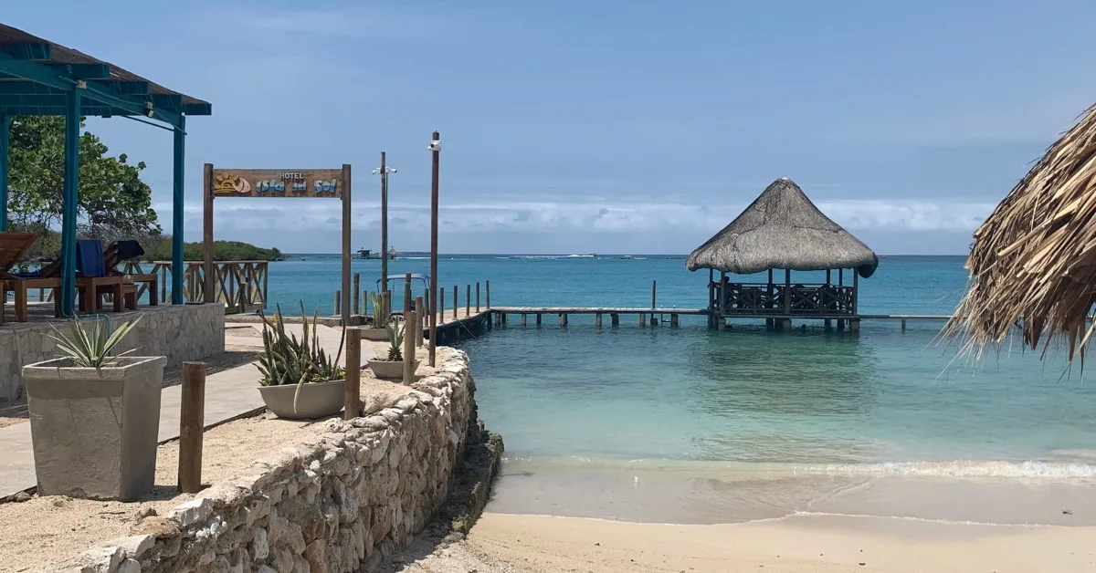 Boat dock at Isla del Sol Hotel with thatched roof arrival jetty and walkway to the main resort.