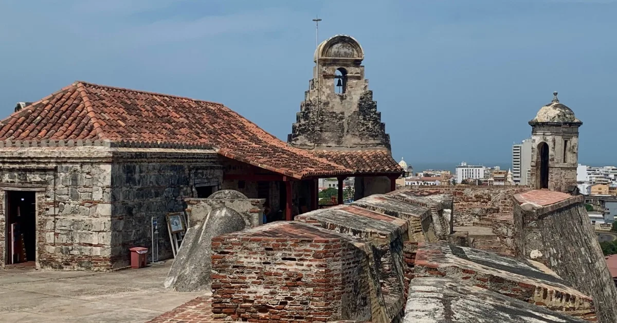 The top of the old fortress with thick stone  and brick defensive walls. Views of the Caribbean Sea in the background.