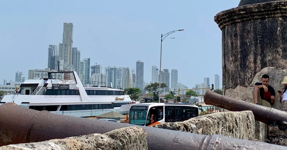 Cartagena city wall next to harbour with boat moored. Bocagrande in distance.
