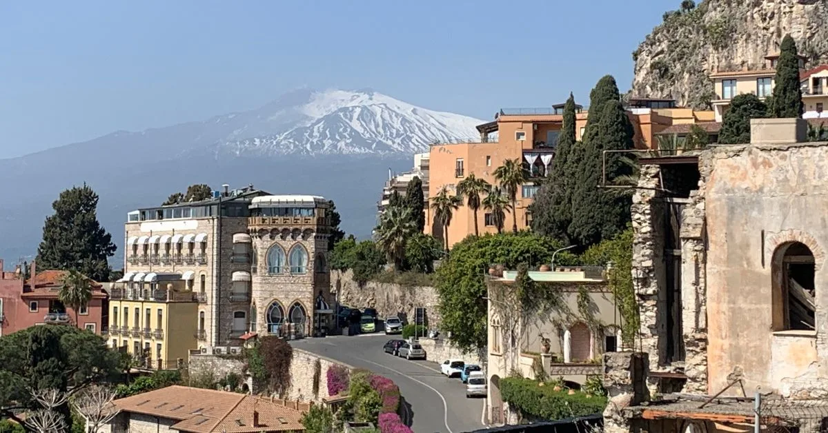 Italian main road with Mount Etna in the background and building in the foreground