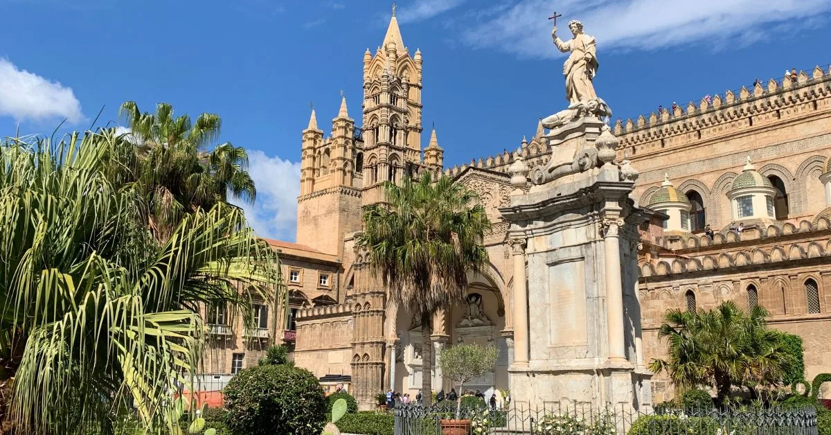 Palermo Cathedral from the front with palm trees outside