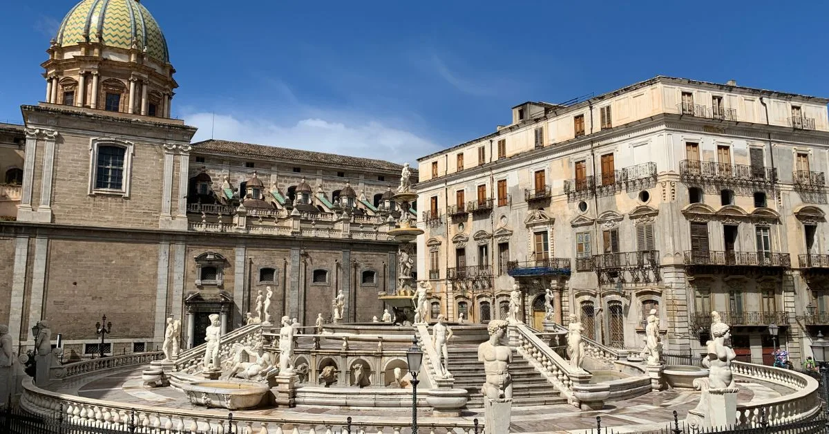 Statues form a circle around a Roman fountain