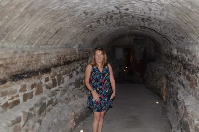 Woman walking through an underground tunnel in Puebla Mexico which were originally for soldiers moving from outside the city.