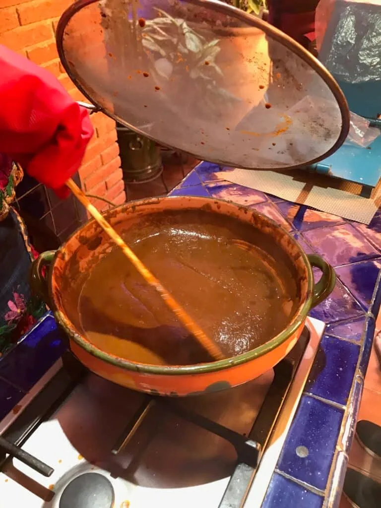 A pot of mole on a stove top.