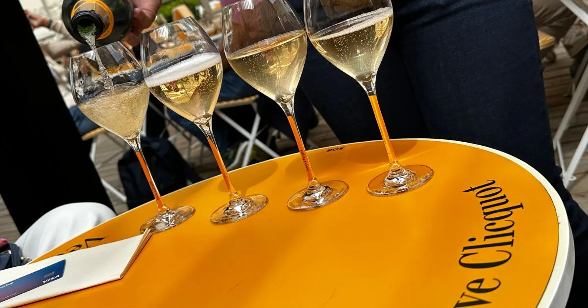 4 glasses of champagne being poured.