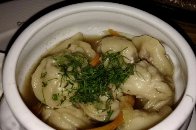 Dumplings in a ceramic dish served.