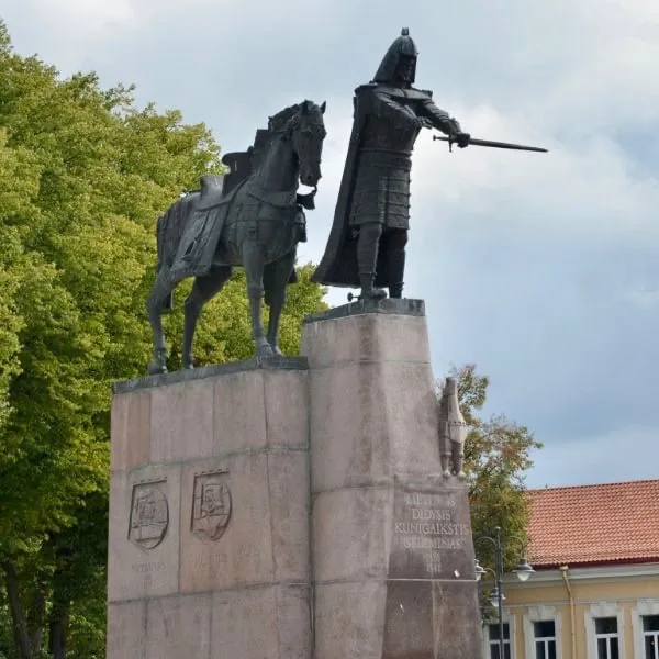 A warrior with an outstretched sword and horse stand on top of a stone block in Vilnius Lithuania.
