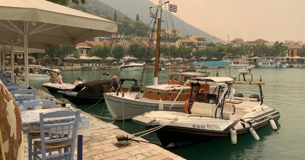 Harbour area with small boats in the water and restaurants dotted around the edge