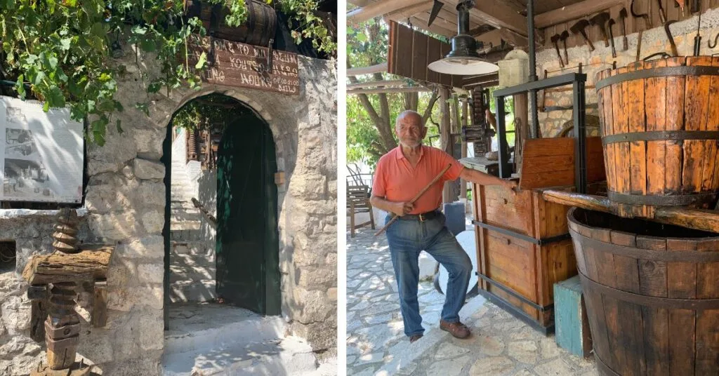 Stone archway entrance to a museum and elderly man standing in museum area next to wooden barrels.