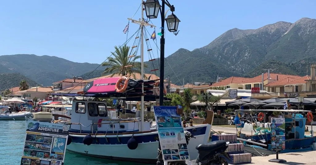 Harbour and promenade area with small boats and tourist information boards