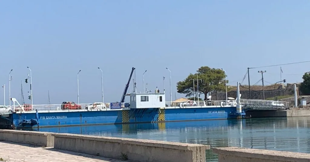 image shows the 'floating ' blue bridge that cars cross to get to Lefkada. Bridge has cars on it
