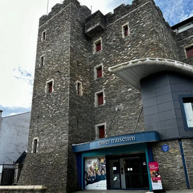 Blue Painted Entrance to the square shaped grey stone tower Museum in Derry.