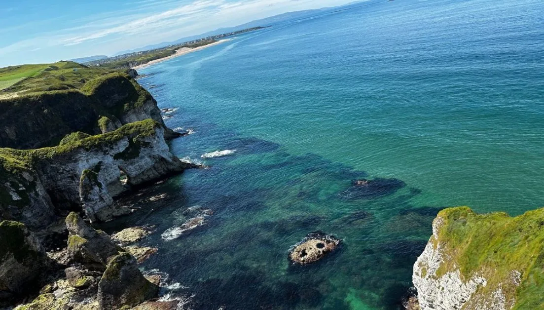 Coastal view of cliffs and blue/green waters seen on a Northern Ireland Itinerary.
