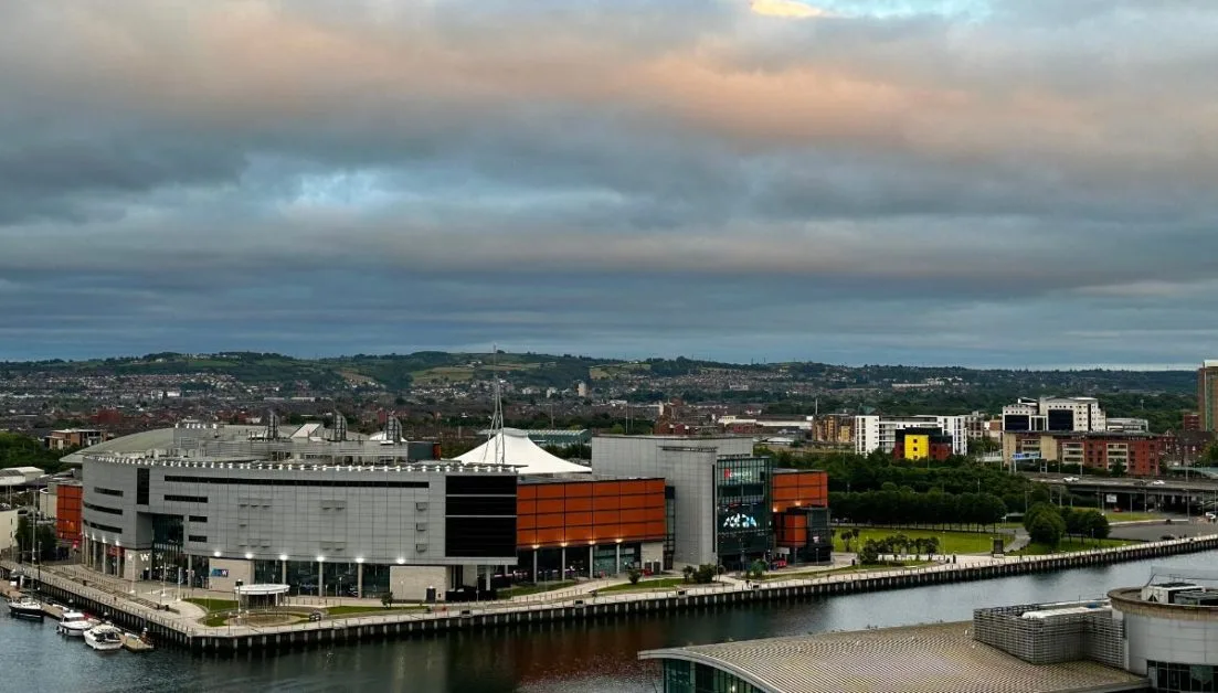 Hotel, cinema complex and restaurants on the waterfront in Belfast. Small boats are docked alongside.
