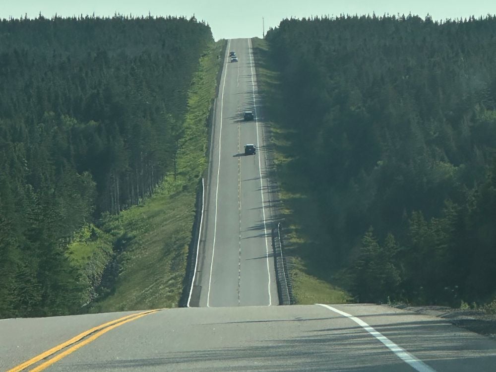 Driving the Cabot Trail scenic highway through forest, Cape Breton