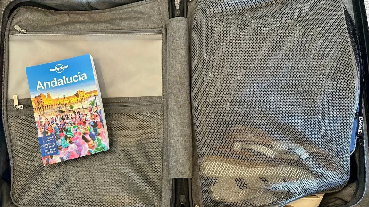 Interior of a carry-on suitcase open showing organised packing compartments