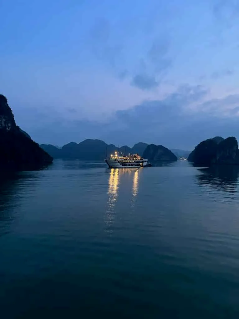 Traditional boat anchored at night in Ha Long Bay Vietnam