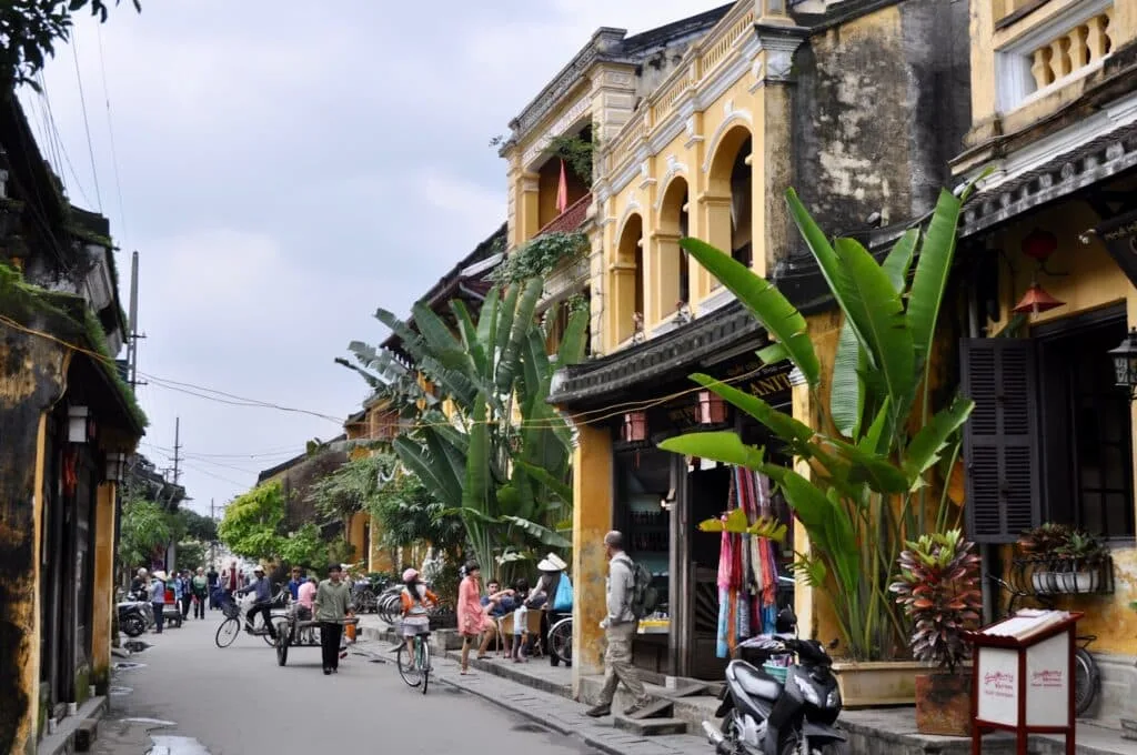Street scene in Vietnam with motorcycles and pedestrians.