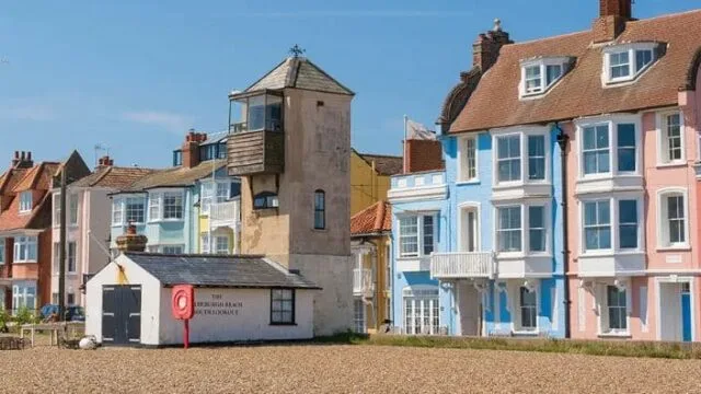 Blue, pink painted homes on the main beach road in Aldeburgh, England