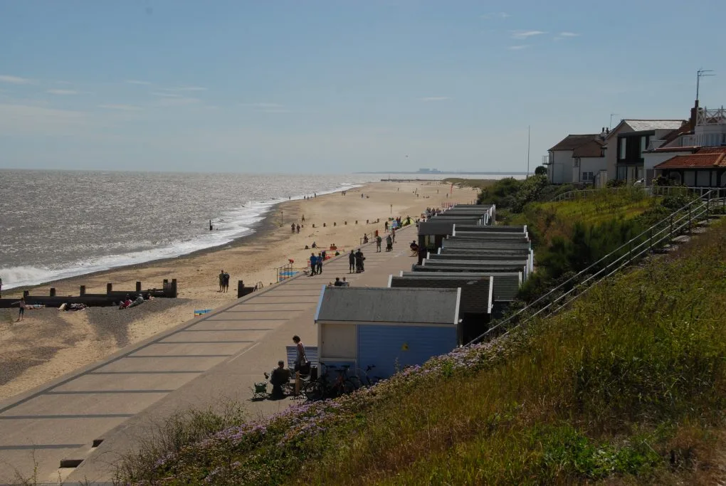 A long promenade stretches along a town parallel to the beach