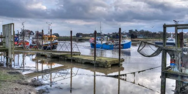 Dusk is falling at the small harbour in Southwold, one of the coastal towns of Suffolk to visit in summer.