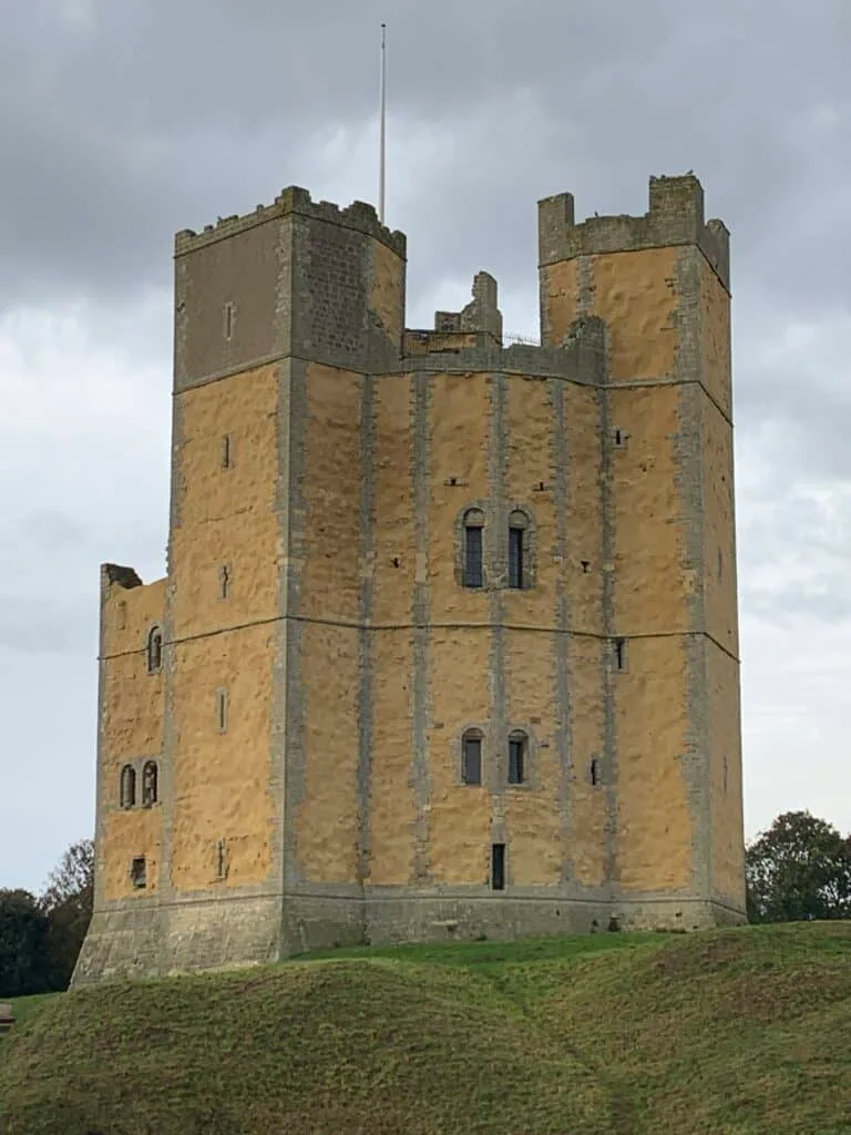 Orford Castle built in a light stone colour with towers and a single structure.