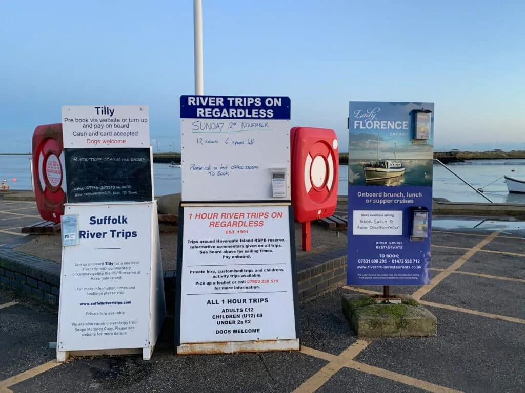 Signs advertising river cruises in Orford, Aldeburgh and Southwold in Suffolk.