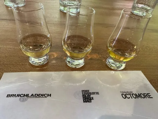 Samples of malt whisky from Islay in 3 glasses with names of each.