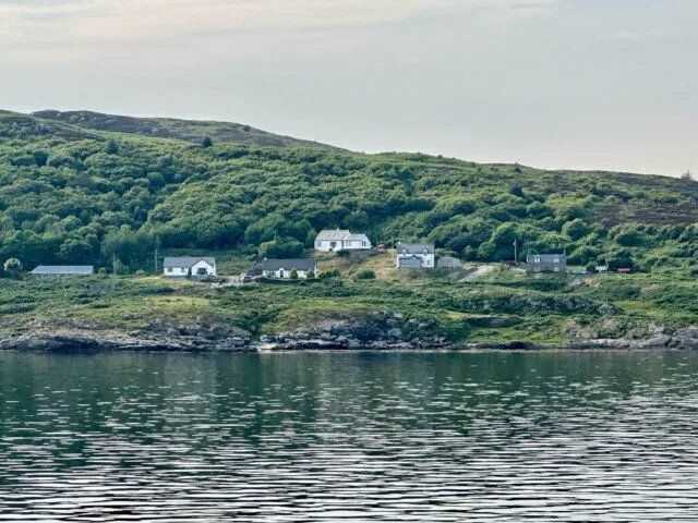 Whitewashed cottages at the shore of Colonsay Scotland