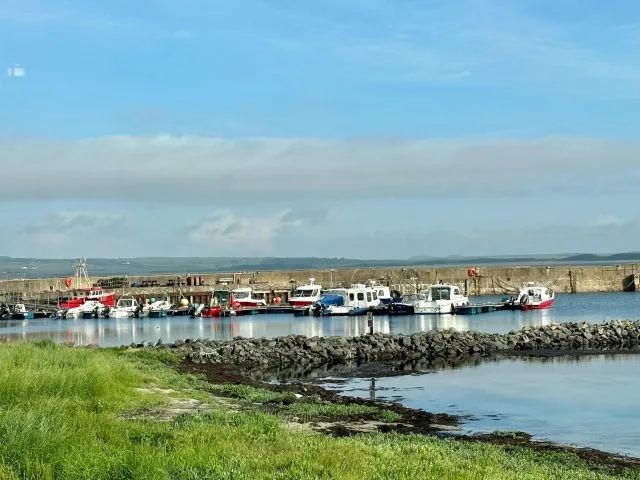 bowman Islay harbour with small fishing boats moored