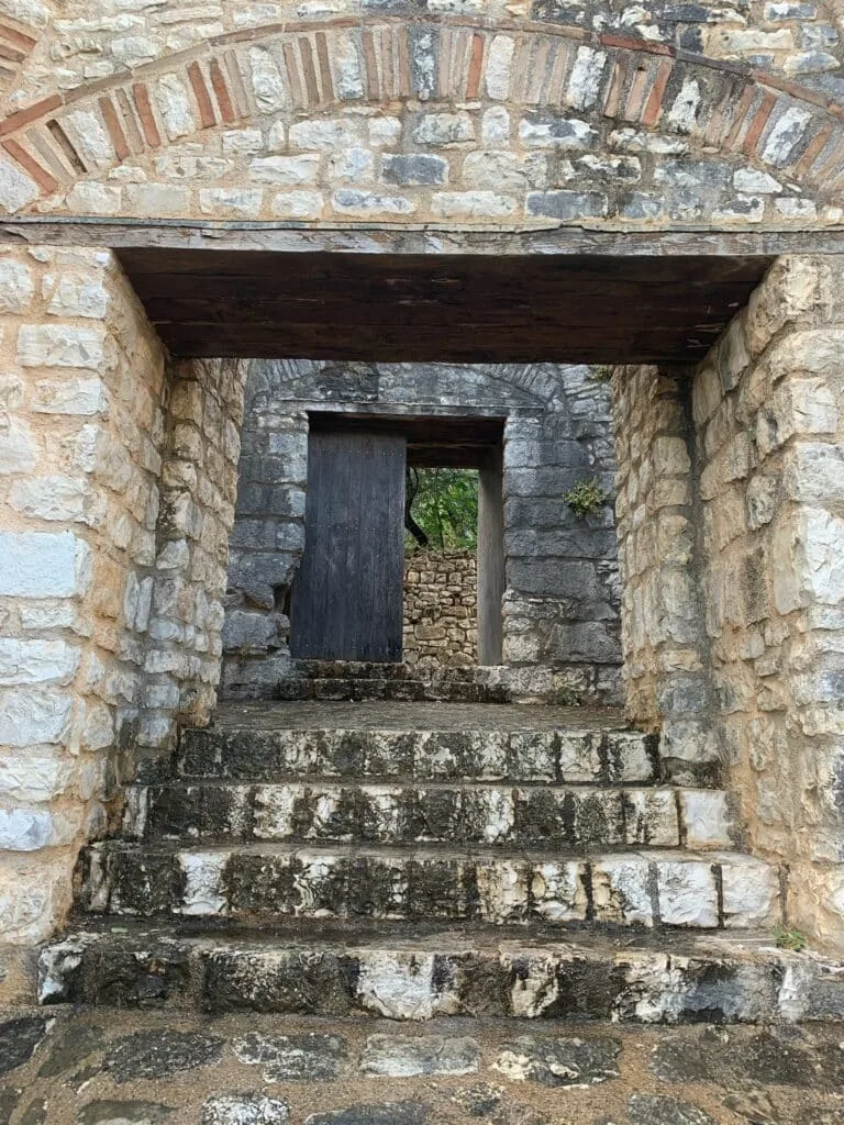 A stone arch forms an entry to a castle in Corfu.