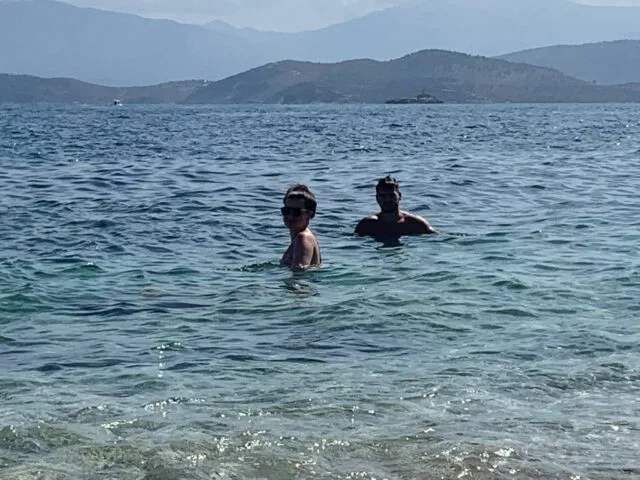 2 People swimming in the ocean in Greece
