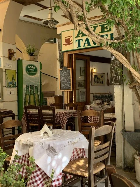 Table and chairs in a small Greek Tavern.