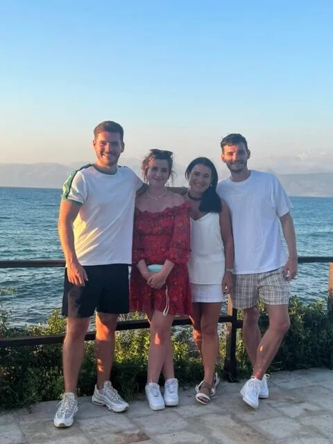 Group of Tourists stand next to the ocean
